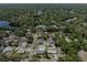 Aerial view of the property, highlighting its location in a well-treed neighborhood near a lake at 301 Wooten Rd, Lutz, FL 33548