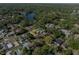 An aerial view showcasing the property's location in a neighborhood setting near a beautiful lake at 301 Wooten Rd, Lutz, FL 33548