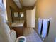 Bathroom featuring tile floors, a toilet, and double vanity with sink at 3257 Bluestone Ave, Spring Hill, FL 34609