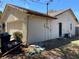 Side exterior of home showing the siding, door, garage and yard, along with landscaping and yard equipment at 3257 Bluestone Ave, Spring Hill, FL 34609