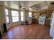 View of a kitchen with tile floors, white appliances, and wood cabinets at 3257 Bluestone Ave, Spring Hill, FL 34609
