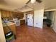View of a kitchen with tile floors, white appliances, and wood cabinets at 3257 Bluestone Ave, Spring Hill, FL 34609