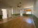 Spacious living room with hardwood floors, a ceiling fan, neutral colors, and baseboards throughout at 3257 Bluestone Ave, Spring Hill, FL 34609