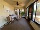 Enclosed sunroom with ceiling fan, tile flooring, and large sliding windows at 3257 Bluestone Ave, Spring Hill, FL 34609
