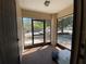 View of the sunroom that has an outdoor view through the glass windows and door at 3257 Bluestone Ave, Spring Hill, FL 34609