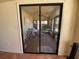 Spacious sunroom view through a glass sliding door with a table set and furniture at 3257 Bluestone Ave, Spring Hill, FL 34609