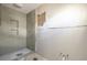 Bathroom featuring a shower, window, and updated lighting at 4061 13Th Ne Ln, St Petersburg, FL 33703