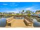 Waterfront homes with private dock on a sunny day with benches, providing access to the water at 4061 13Th Ne Ln, St Petersburg, FL 33703