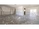 Spacious living room under construction, featuring freshly painted walls and concrete floors at 4061 13Th Ne Ln, St Petersburg, FL 33703