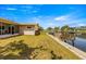 Backyard featuring a patio, a private dock, and picturesque canal setting at 4061 13Th Ne Ln, St Petersburg, FL 33703