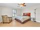 Bedroom with wood-look tile flooring, ceiling fan, and comfortable furniture at 4109 Rudder Way, New Port Richey, FL 34652