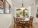 Bright dining area features a round table, large bay window overlooking the pool, and a stylish light fixture at 428 Pine Bluff Dr, Lutz, FL 33549