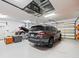Spacious three-car garage with epoxy floors, ample storage, and modern lighting, perfect for vehicles and hobbies at 428 Pine Bluff Dr, Lutz, FL 33549