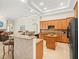 Open kitchen with granite countertops, central island, and stainless steel appliances at 428 Pine Bluff Dr, Lutz, FL 33549