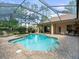 Inviting backyard pool with spa, screened-in enclosure, and lush landscaping for privacy and enjoyment at 428 Pine Bluff Dr, Lutz, FL 33549