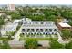 Aerial view of modern townhomes with balconies, landscaping, and a vibrant green neighborhood at 4515 W North A St # 4, Tampa, FL 33609
