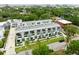 Aerial view of townhomes with balconies, landscaping, and nearby city skyline in the background at 4515 W North A St # 4, Tampa, FL 33609