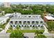 An aerial view of modern townhomes surrounded by lush landscaping and mature trees at 4515 W North A St # 4, Tampa, FL 33609