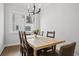 Bright dining room featuring a modern chandelier, wood table, and large window at 4515 W North A St # 4, Tampa, FL 33609