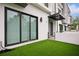 Contemporary townhome exterior with a small private yard and sleek architectural details at 4515 W North A St # 4, Tampa, FL 33609