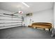 Spacious garage with a modern garage door, gray painted floor, and neatly stacked lumber at 4515 W North A St # 4, Tampa, FL 33609