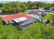 Backyard aerial view of a home with a screened-in pool, and well maintained lawn at 4555 Debbie Ln, Lutz, FL 33559