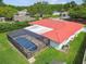 Aerial view of the house featuring a red tile roof and screened-in pool at 4555 Debbie Ln, Lutz, FL 33559
