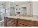 Bathroom with double sinks, marble countertops, and dark wood cabinetry at 4555 Debbie Ln, Lutz, FL 33559
