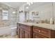 This bathroom is decorated with granite countertops and a glass shower at 4555 Debbie Ln, Lutz, FL 33559