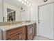 Bathroom featuring double sinks with marble countertops and dark wood cabinetry, next to a linen closet at 4555 Debbie Ln, Lutz, FL 33559