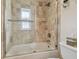 A well-lit bathroom featuring a shower with glass doors and a tub at 4555 Debbie Ln, Lutz, FL 33559