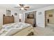 Comfortable bedroom with a wooden dresser, ceiling fan, and neutral-toned decor at 4555 Debbie Ln, Lutz, FL 33559
