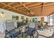 Inviting covered patio featuring tile flooring, a ceiling fan, and ample space for outdoor seating and entertaining at 4555 Debbie Ln, Lutz, FL 33559