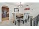 Elegant dining room with neutral colors, modern lighting fixture, and comfortable seating for six near the kitchen at 4555 Debbie Ln, Lutz, FL 33559