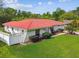 Charming single-story home featuring a red tile roof and manicured lawn at 4555 Debbie Ln, Lutz, FL 33559