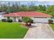 Inviting home showcasing a well-maintained lawn, driveway, and a red tile roof at 4555 Debbie Ln, Lutz, FL 33559
