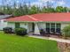 Charming single-story home featuring a red tile roof, well-manicured lawn, and inviting curb appeal at 4555 Debbie Ln, Lutz, FL 33559