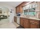 Bright kitchen with a window overlooking the screened-in patio, featuring stainless steel appliances and mosaic tile backsplash at 4555 Debbie Ln, Lutz, FL 33559
