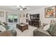 Spacious living room with sliding glass doors to the patio and comfortable seating near the kitchen at 4555 Debbie Ln, Lutz, FL 33559