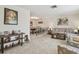 Inviting living room featuring neutral carpet, complementing decor, and bright light with easy dining room access at 4555 Debbie Ln, Lutz, FL 33559