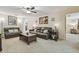 Comfortable living room with a ceiling fan, soft lighting, and easy access to other rooms of the house at 4555 Debbie Ln, Lutz, FL 33559