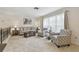 Cozy living room featuring a large window, neutral colors, comfortable seating, and bright natural light at 4555 Debbie Ln, Lutz, FL 33559