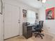 A home office space with desk, chair, and art at 4555 Debbie Ln, Lutz, FL 33559