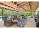 Relaxing outdoor screened patio featuring comfortable seating, ceiling fans, and views of lush greenery at 4555 Debbie Ln, Lutz, FL 33559
