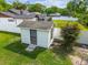 Backyard shed providing extra storage space and a small bench, surrounded by green grass at 4555 Debbie Ln, Lutz, FL 33559
