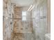 Tiled shower with glass door and built-in bench at 4555 Debbie Ln, Lutz, FL 33559