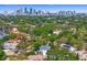 Expansive aerial view of a residential neighborhood surrounded by lush green trees and city skyline beyond at 47 Martinique Ave, Tampa, FL 33606