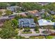 A high angle view showcases a home with driveway and manicured lawn, in an upscale neighborhood at 47 Martinique Ave, Tampa, FL 33606