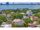 Captivating aerial view of waterfront homes nestled among lush greenery, with the city skyline in the distance at 47 Martinique Ave, Tampa, FL 33606