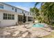 Spacious backyard features a pool, spa, screened lanai, and lush landscaping, perfect for outdoor living at 47 Martinique Ave, Tampa, FL 33606